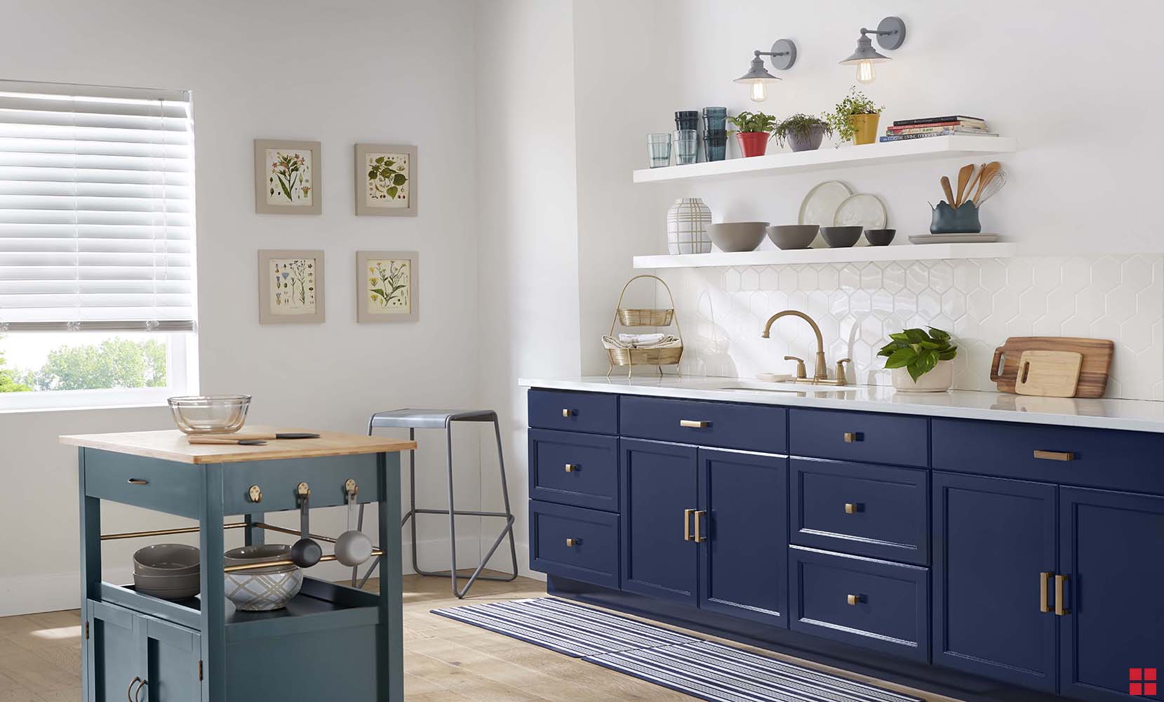 A kitchen with a green island and navy blue cabinets. 