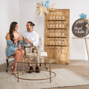 Man and woman sitting in a room with beach wedding décor.