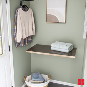 Folding Shelf Open On The Wall With Folded Towels On It
