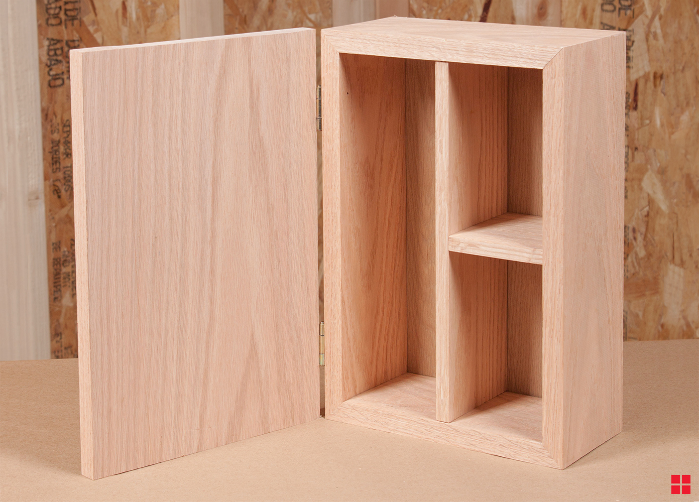 A bare wood box with an open door and three compartments inside.
