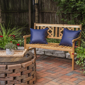 Wood bench with a teak oil finish on brick patio.