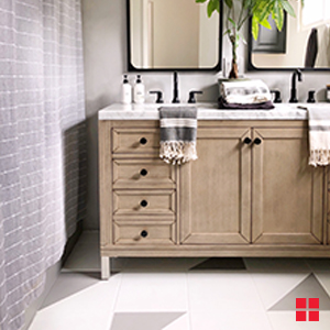 Wood vanity on an off-white and gray painted bathroom tile floor. 