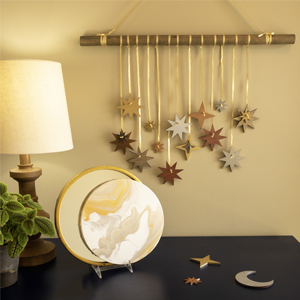 Hanging wall décor featuring metallic painted stars.