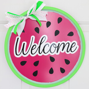 Pizza pan door wreath painted as a watermelon. 