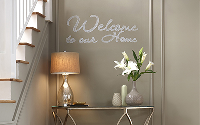 Clear chalkboard paint painted over wall. Cursive writing was then written on the wall.
