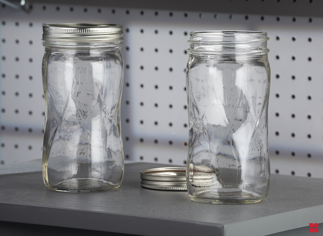 Two unpainted glass jars. 