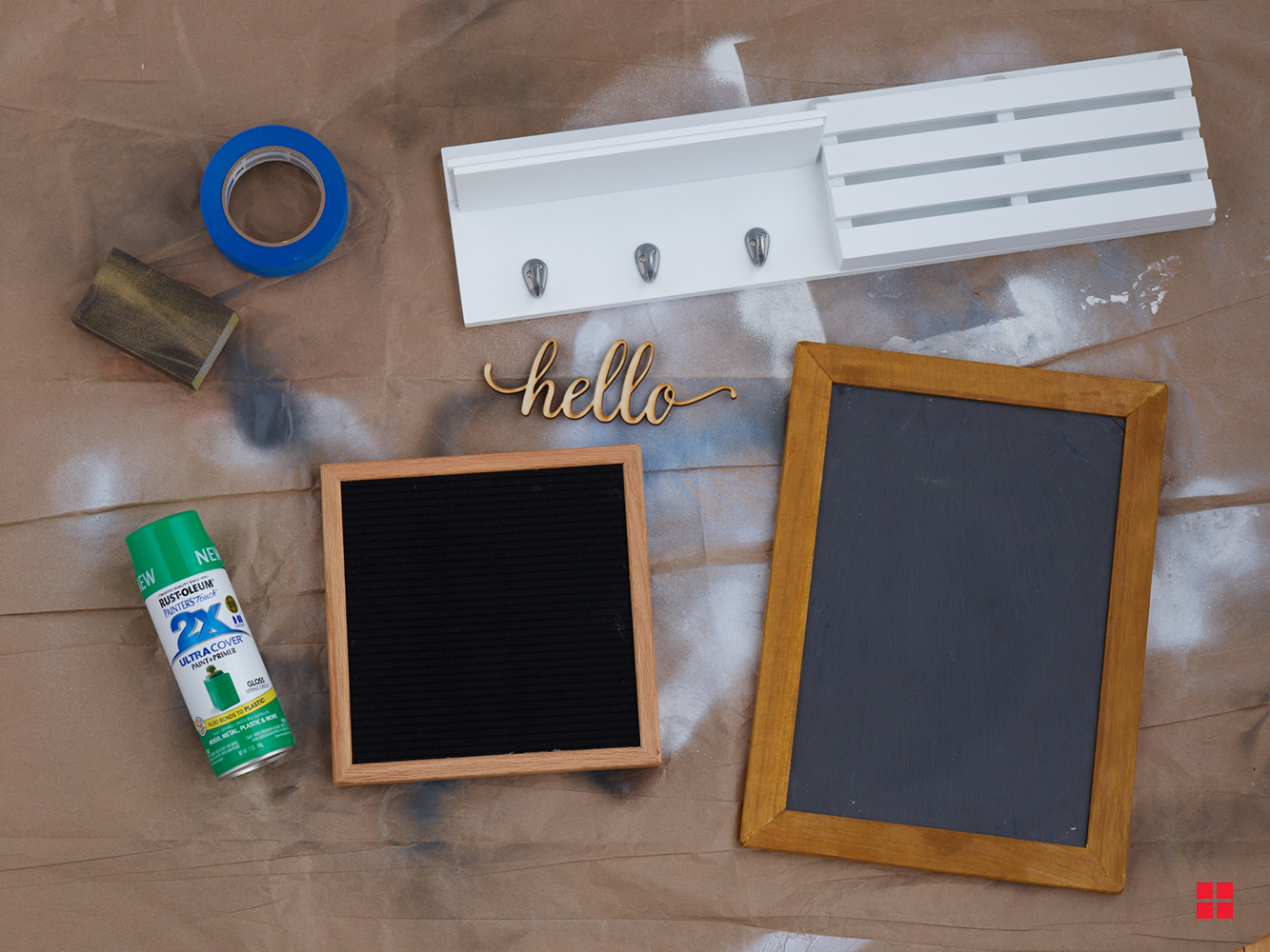 Unpainted shelf, message board and chalkboard next to a can of green spray paint.