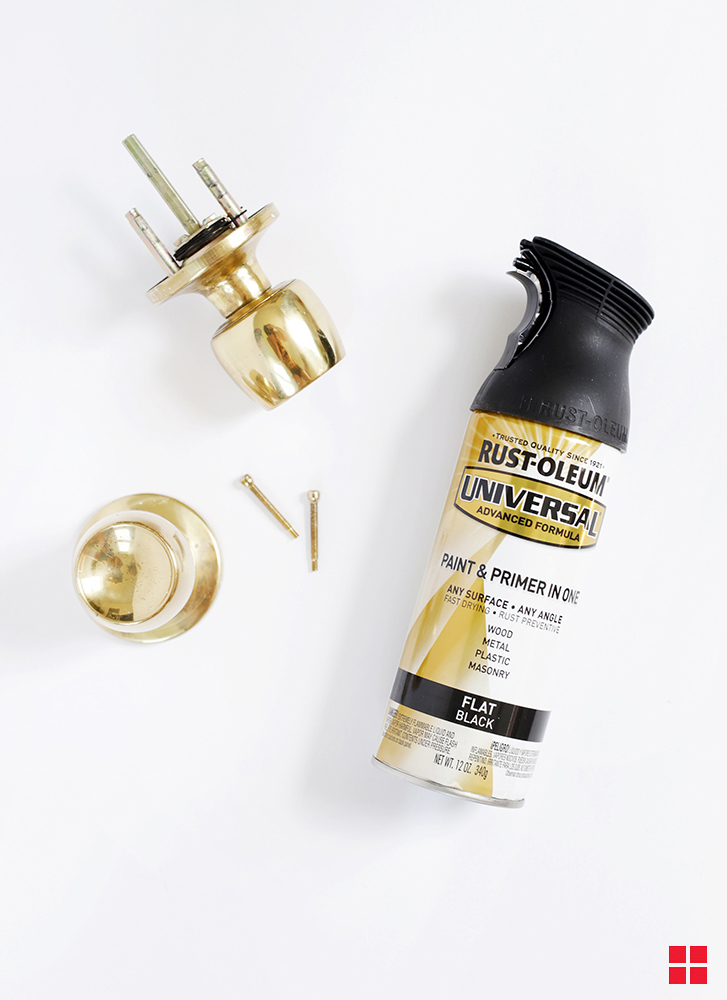 Dissembled brass door knob next to a can of Rust-Oleum Universal Metallic Spray Paint. 