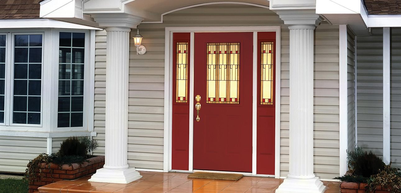 A home’s porch and a red front door. 
