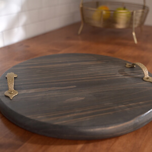 Stained wood round with a handle on either side.