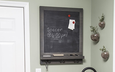 Magnetic chalkboard with hooks.