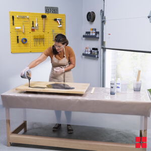Pouring The Activated Mixture Onto Wood Shelf 