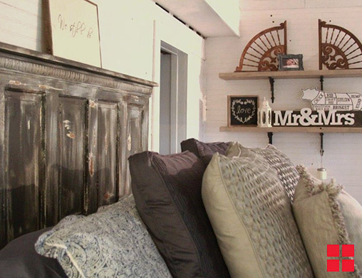 Rustic door used as a headboard.