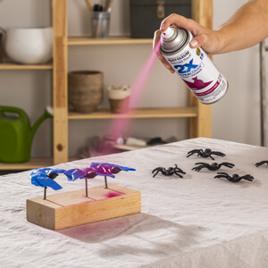 Applying Rust-Oleum 2X Ultra Cover Spray Paint to plastic spiders. 