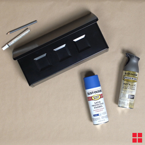 Black mailbox, two cans of Rust-Oleum spray paint, pencil and pain pen.