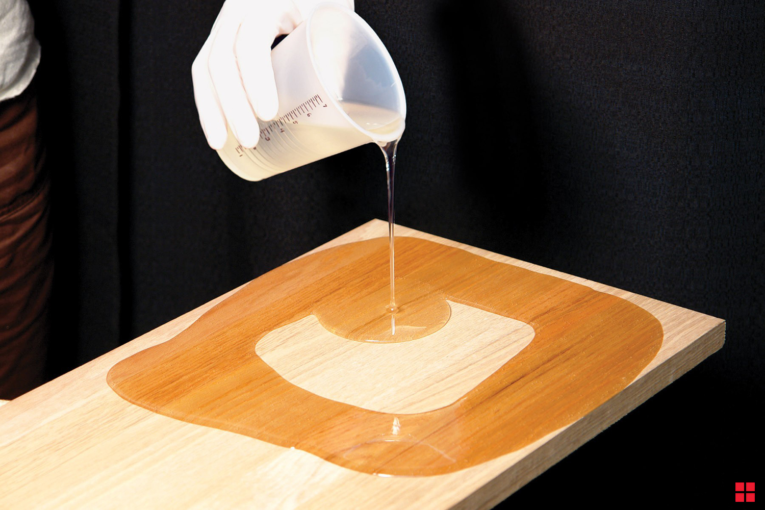 Pouring clear epoxy resin on bare wood.