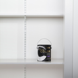 A can of white Studio Color Wall Paint on a closet shelf.