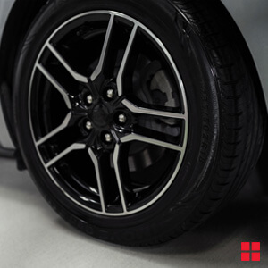 Car tire after Wipe New Tire Shine is applied.