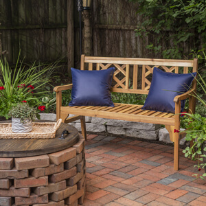 Two blue pillow on a patio bench.