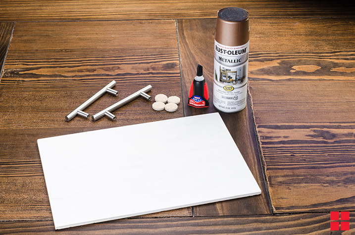 Plain white cutting board, unattached silver handles and a can of Rust-Oleum Stops Rust Spray Paint. 