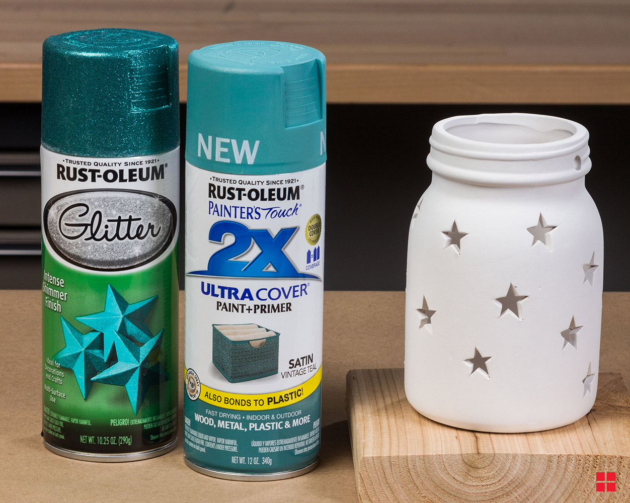 Two cans of Rust-Oleum spray paint next to unpainted star jar.