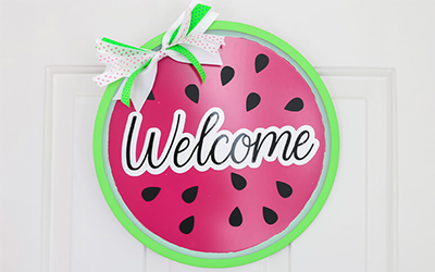 Pizza pan door wreath painted as a watermelon. 