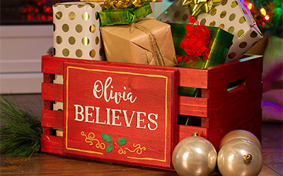 Wood crate painted red with personalized plaque.