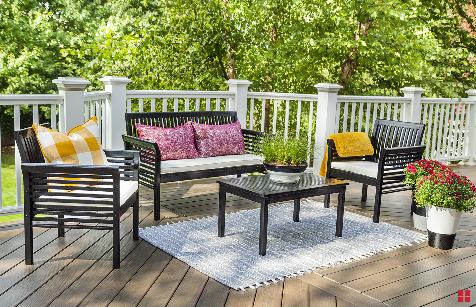 Wooden benches, table and chair on an outdoor deck.