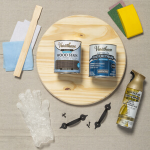 Bare wood board, cans of Varathane wood stain, a can of Rust-Oleum spray paint and other supplies.