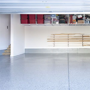 A garage with a shiny gray floor and black and white speckles.