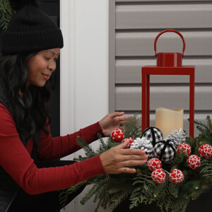 Video image. Woman arranging lantern wreath.