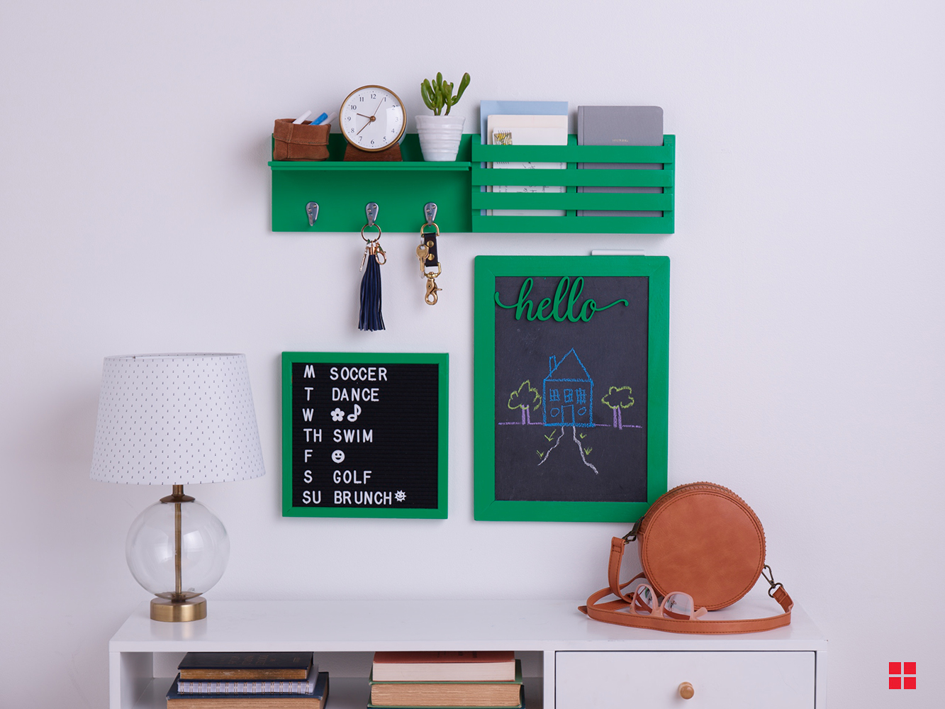Green shelf, message board and chalkboard on a wall. 