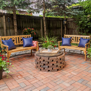 Finished patio with brick fire pit and stained wood fire pit cover